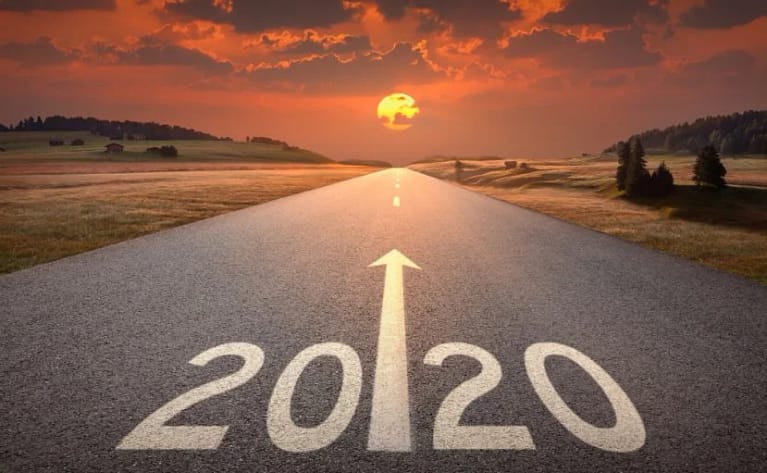 Image of road during sunset with 2020 painted on it and an arrow